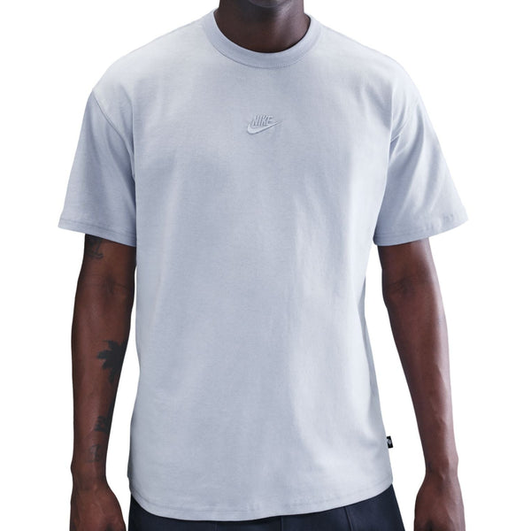 Person wearing a light gray Nike t-shirt on a white background