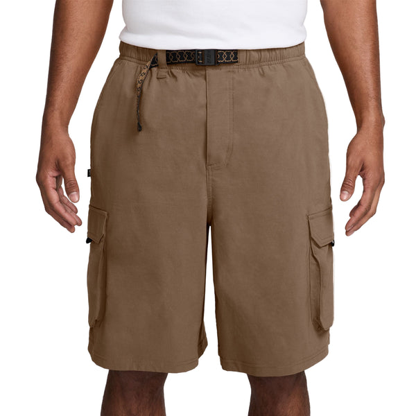 Brown cargo shorts worn by a person on a white background