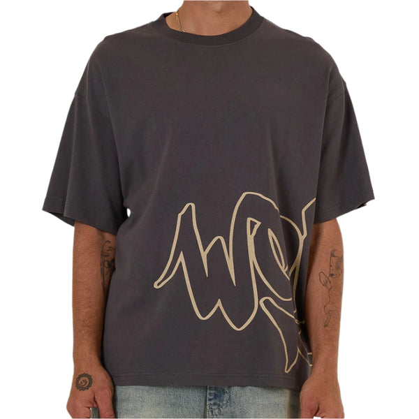 Man wearing a dark gray t-shirt with a logo on a white background