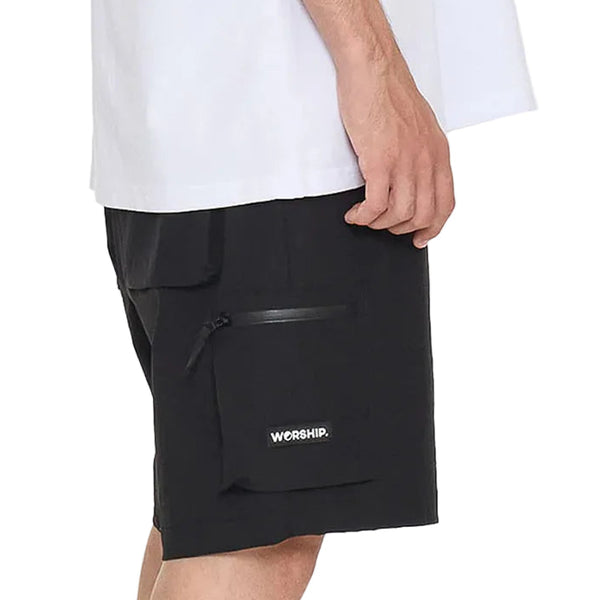 Person wearing black cargo shorts with a visible brand logo on a white background