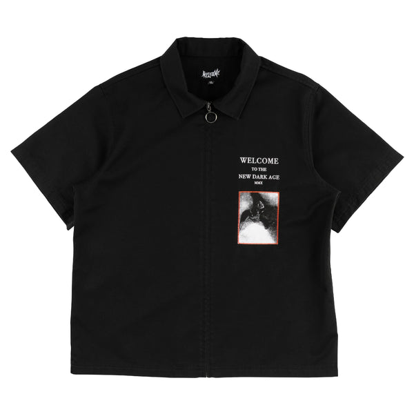Black polo shirt with graphic design and text on a white background