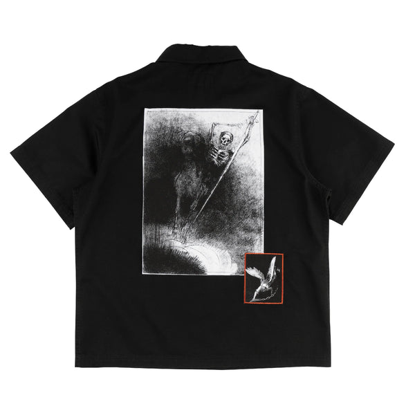 Black shirt with a graphic design on the back featuring a skeleton holding an umbrella.