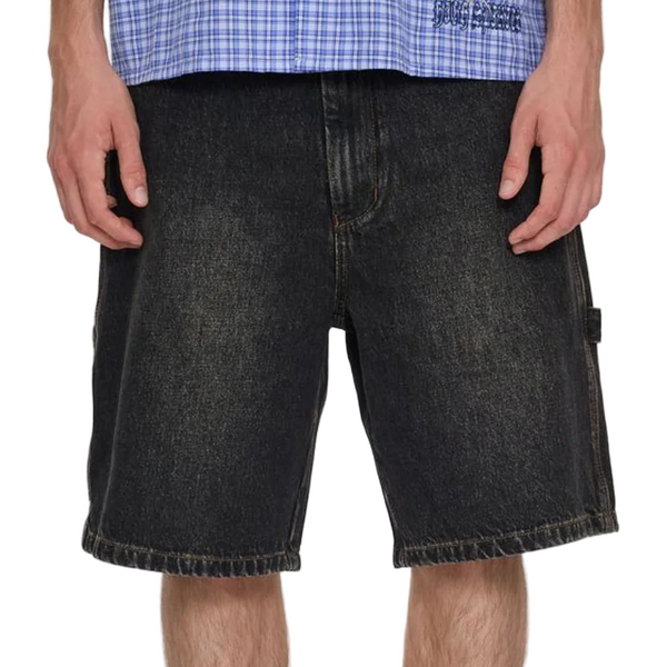 Person wearing black denim shorts on a white background