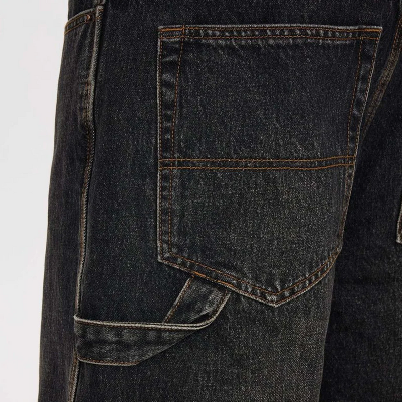 Close-up of black jean shorts with a pocket on a white background